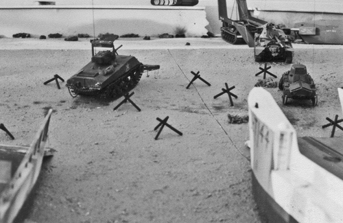 Radio controlled model tanks on the beachead after unloading from the landing craft
